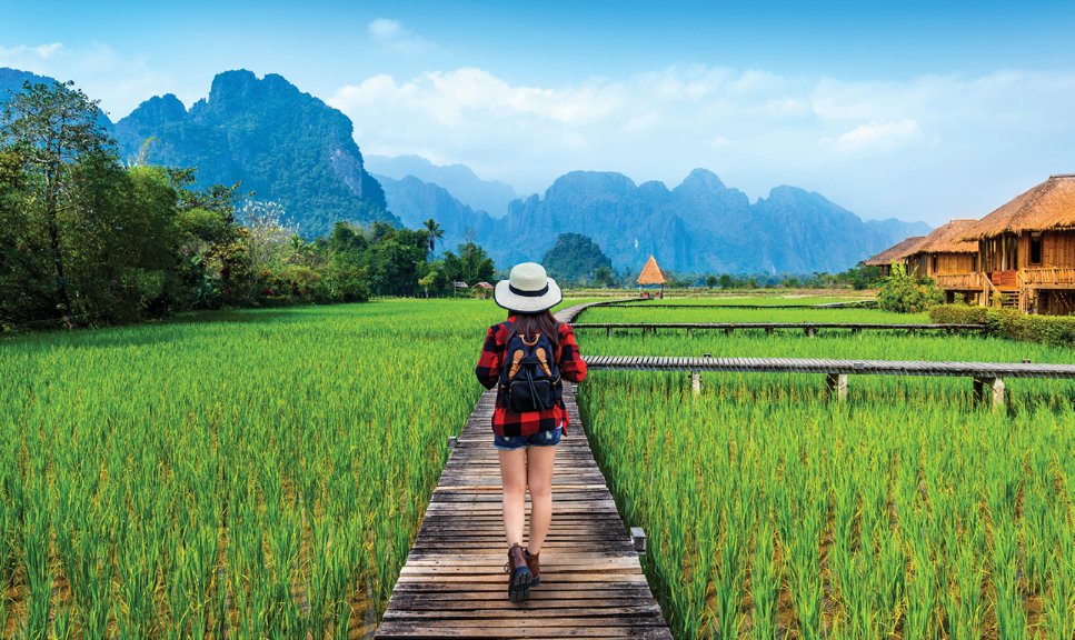 tourism-with-backpack-walking-wooden-path-vang-vieng-laos.jpg