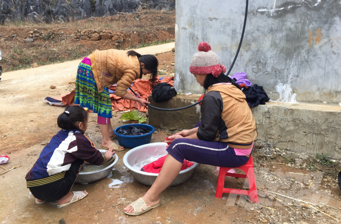 Người dân tộc Mông xóm Lũng Ngần, xã Hồng Sỹ, huyện Hà Quảng sử dụng nước tại bể nước tập trung. Ảnh: Công Hải.