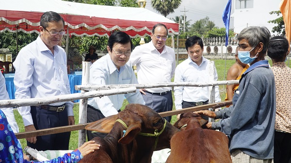 Nguyên Chủ tịch nước Trương Tấn Sang và ông Đặng Hoài Đức - Phó TGĐ Ngân hàng Vietcombank dặn dò người dân chăm sóc tốt bò giống.